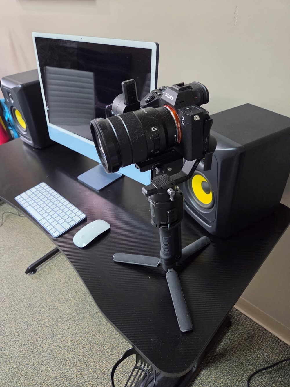 The gimbal rig beside the edit station and studio monitors
